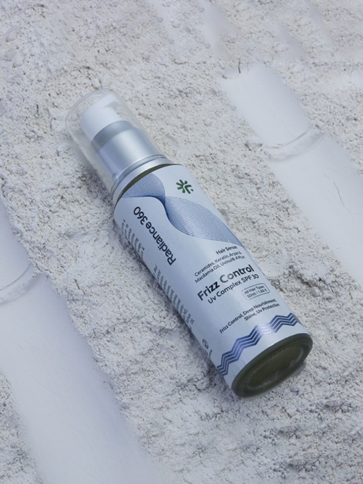Spray bottle labeled 'Frizz Control' on a textured surface