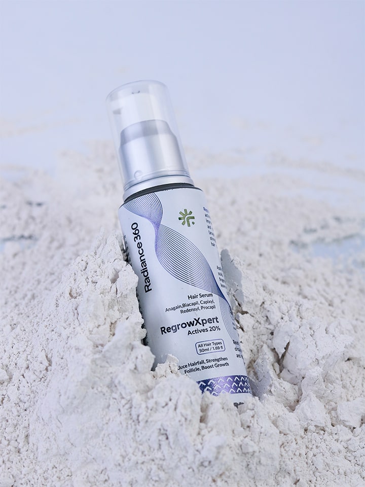 Radiance 360 RegrowXpert hair serum bottle on a textured white surface